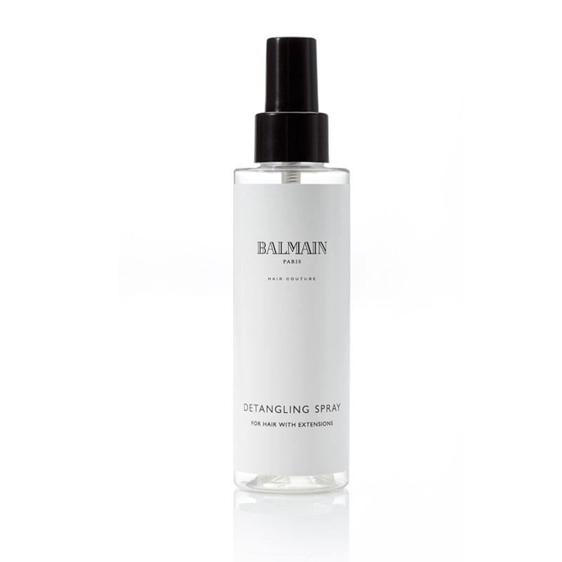 Flacone trasparente e cilindrico dello spray districante Balmain Paris con erogatore a pompa nero ed etichetta bianca su sfondo bianco.