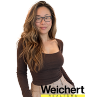 Portrait of a smiling woman with glasses in a brown top on a white background, with Weichert logo below