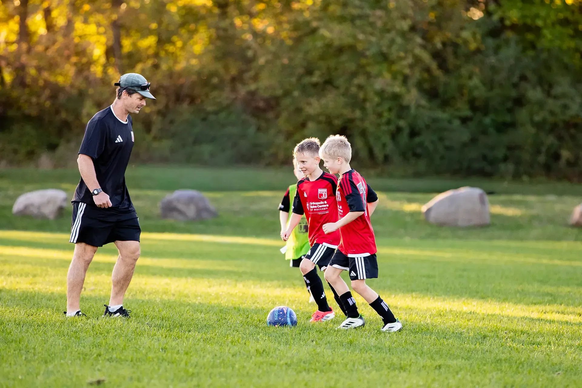 Coaching staff member leading a training session on the field