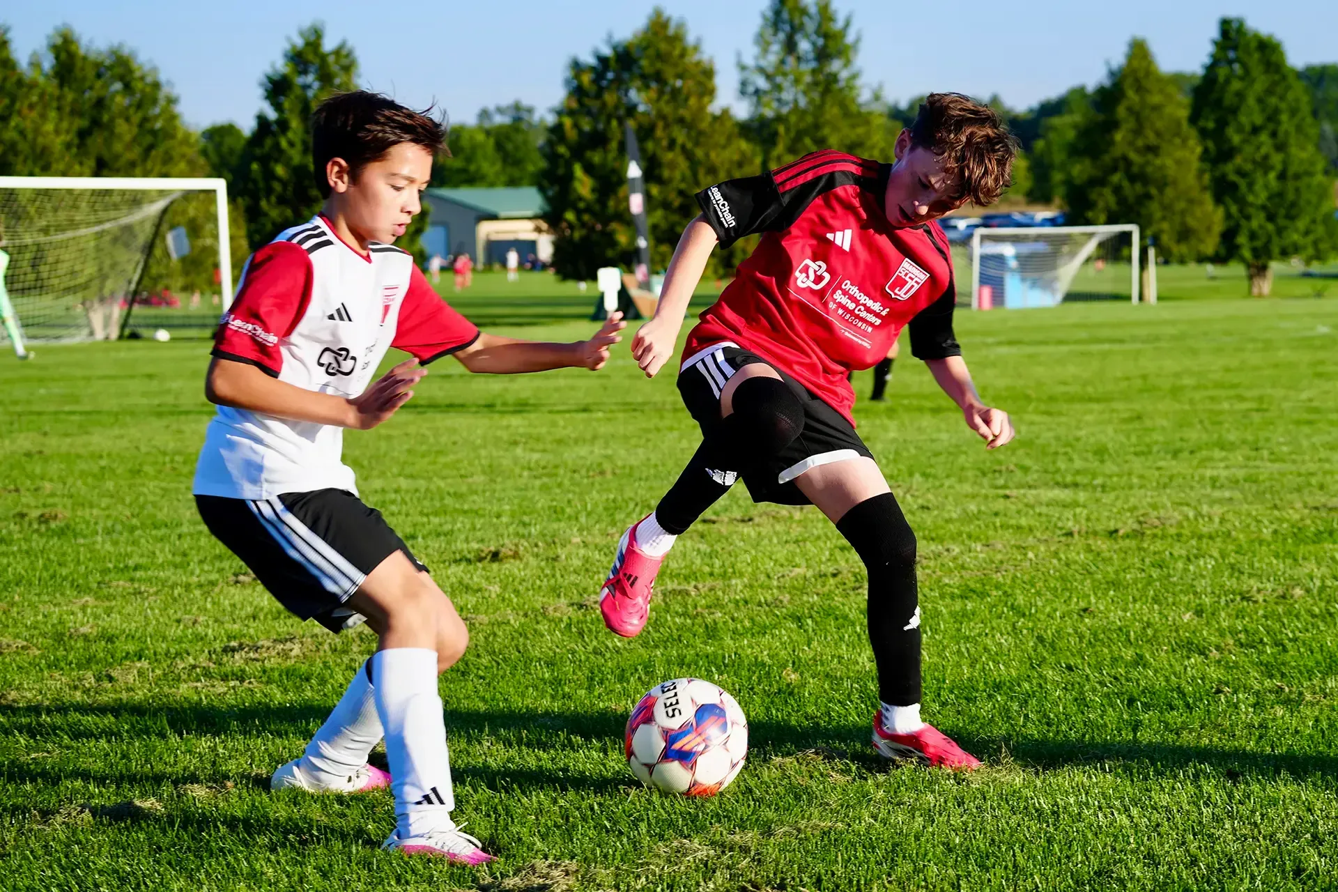 Young player dribbling past a cone during a tryout session