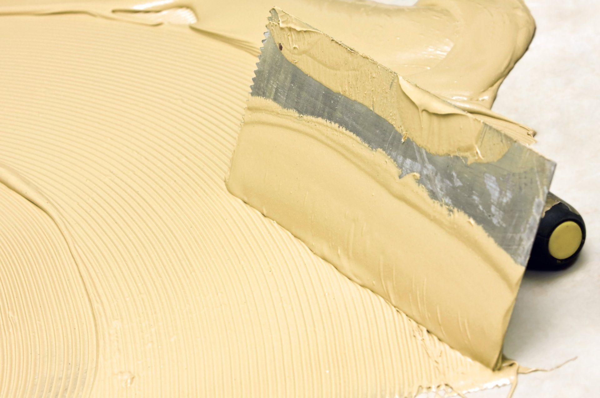 FRP glue on trowel being spread on back of panel