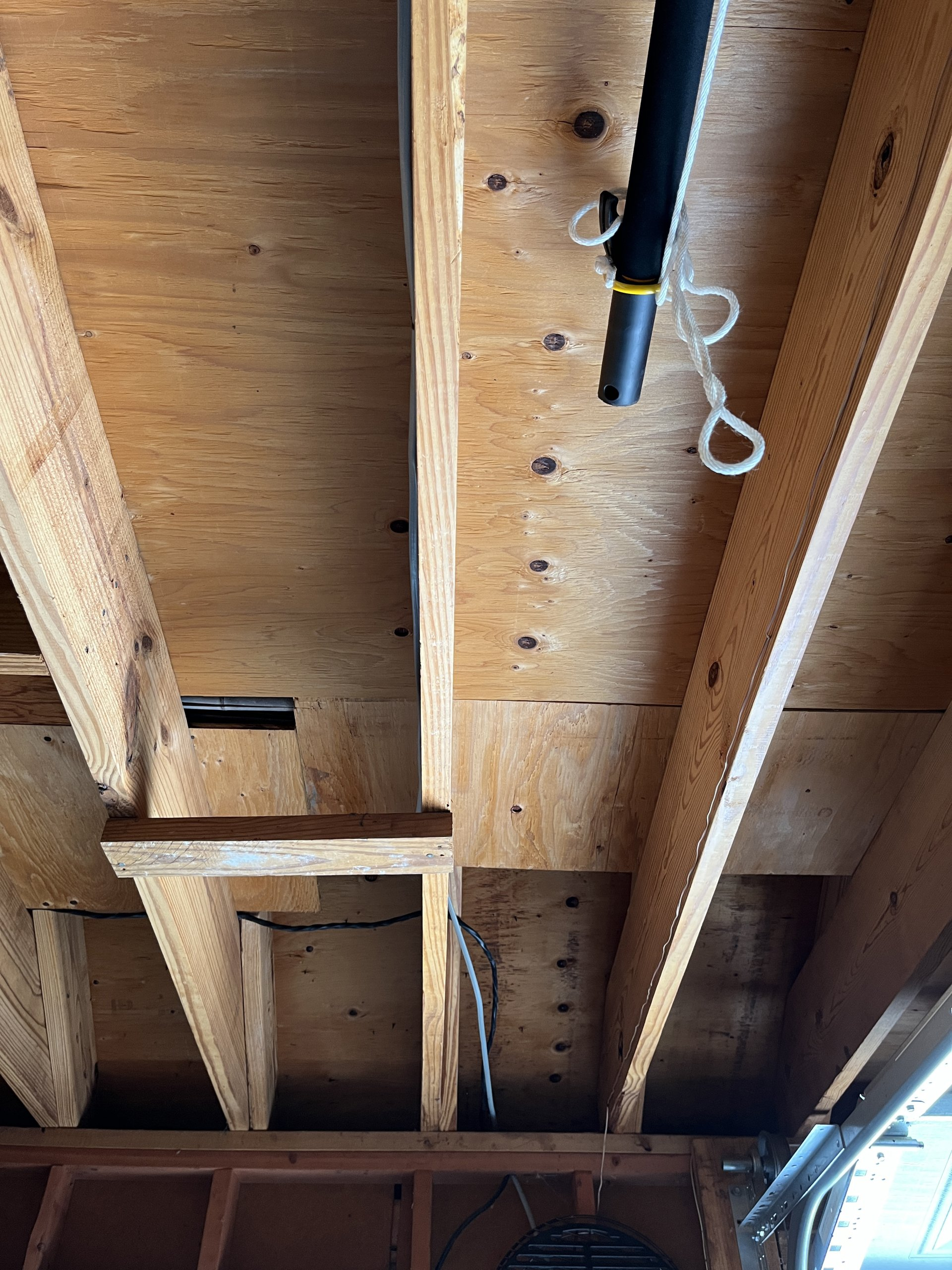 garage rafters in need of drywall treatment to finish off the job
