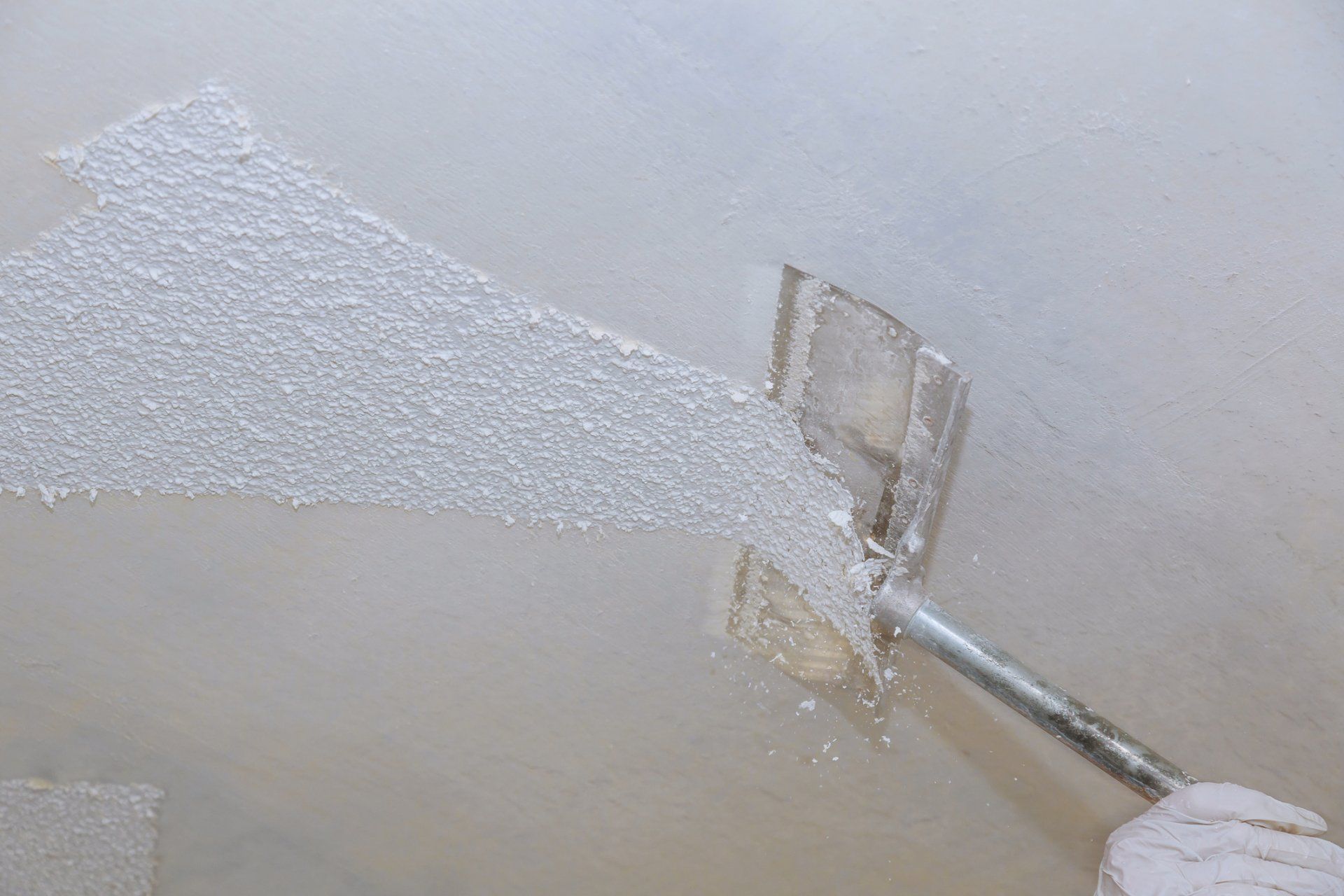 popcorn texture being removed by moisture and scraper