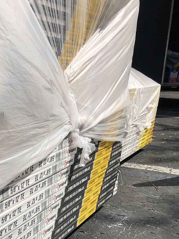 two stacks of drywall on pallets