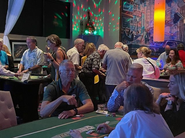 A group of people are sitting around a table playing poker.