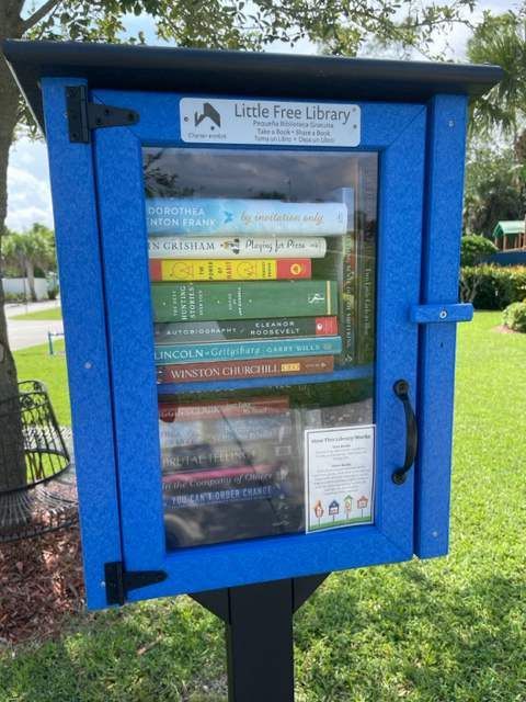A blue little free library box filled with books