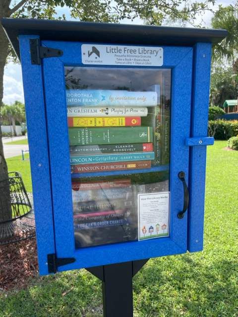 A blue little free library box filled with books