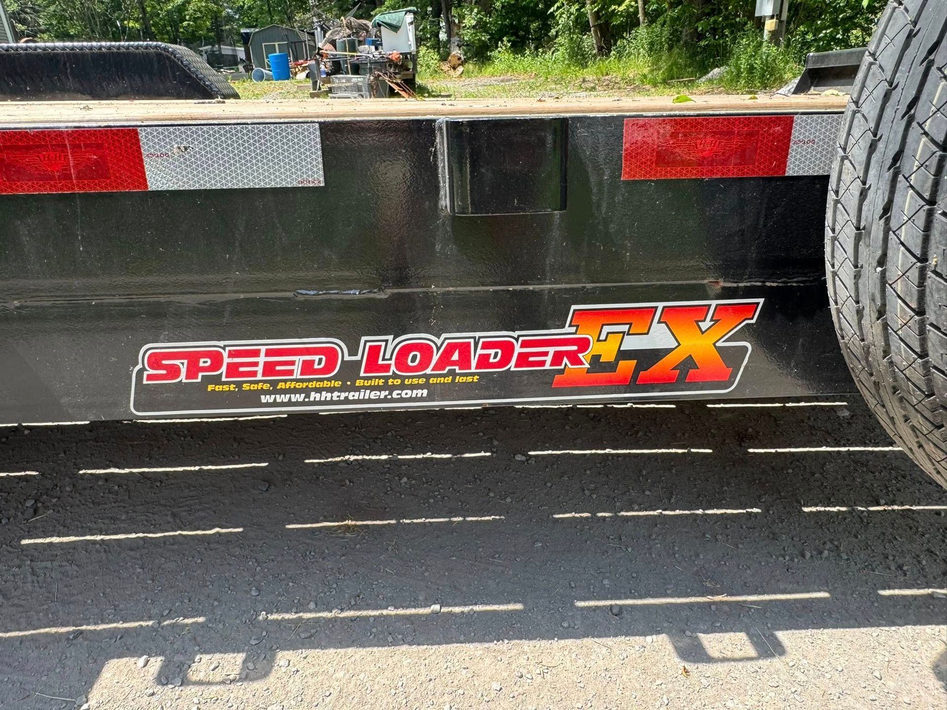 Rear of a black Speed Loader CX trailer with red and silver decals and reflectors