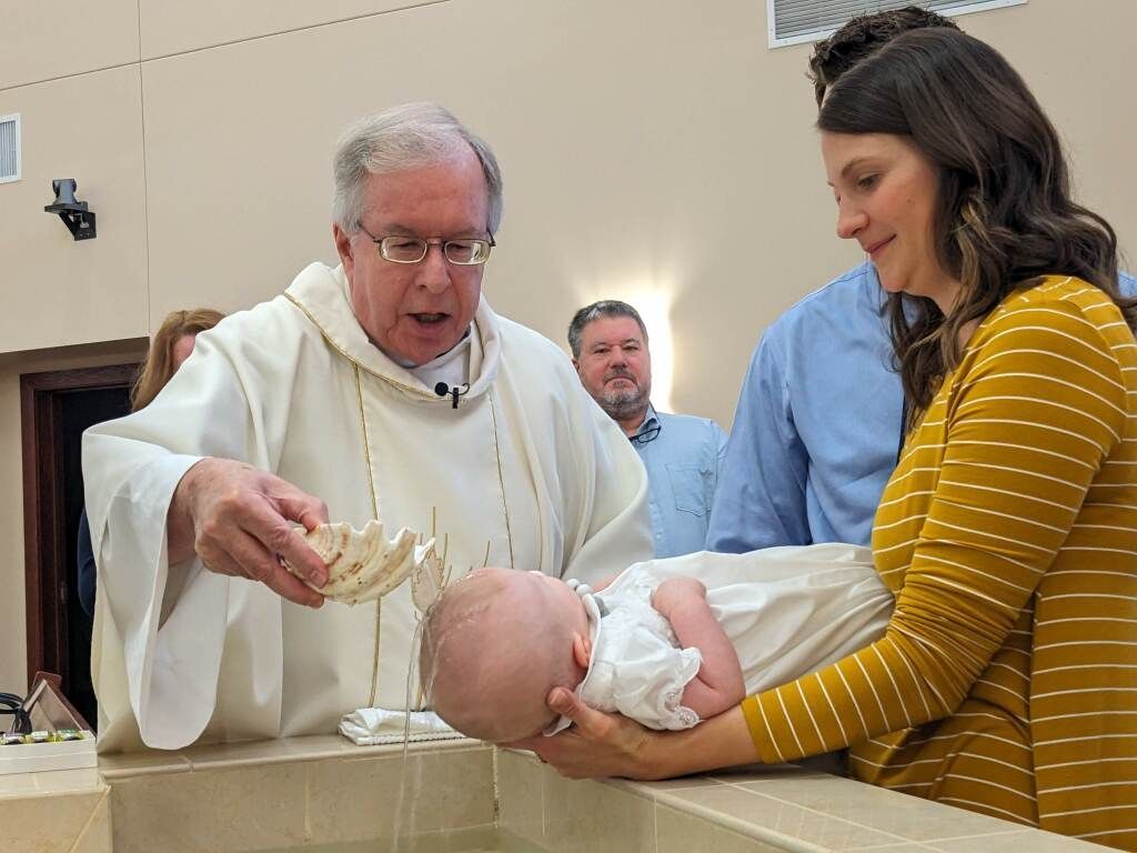 Baptism, water going on baby's head