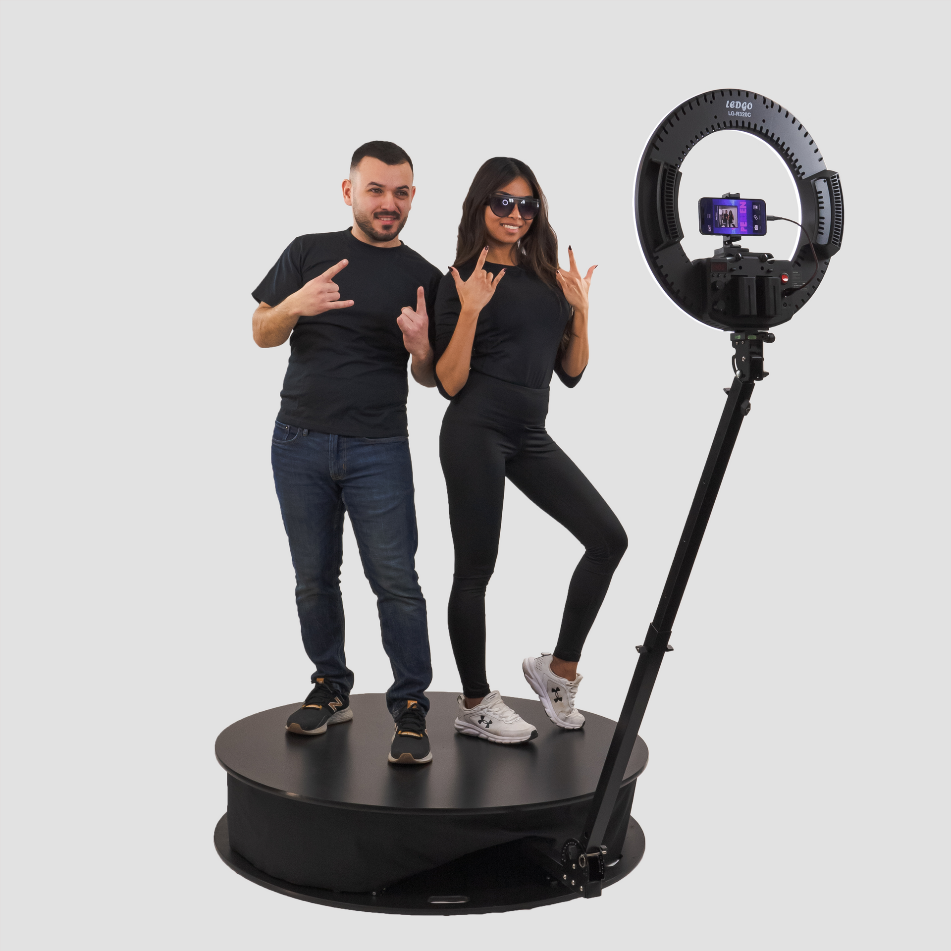 A man and a woman are standing next to each other on a rotating platform.