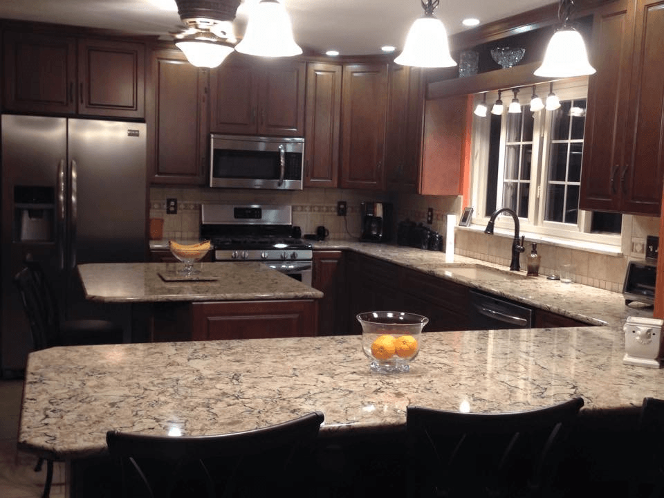 A kitchen with granite counter tops and stainless steel appliances