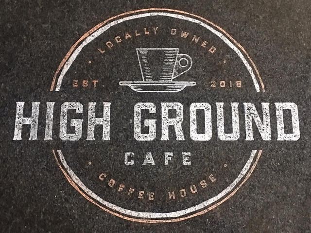 A logo for high ground cafe with a cup of coffee on a saucer