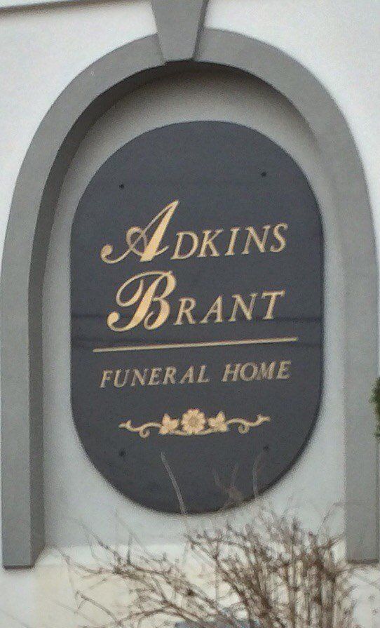 A sign that says adkins brant funeral home