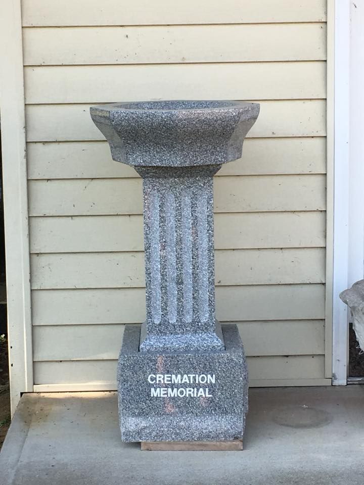 A bird bath with the words cremation memorial written on it