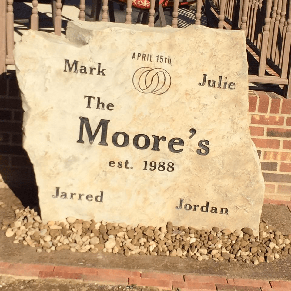 A large stone with the name moore 's on it