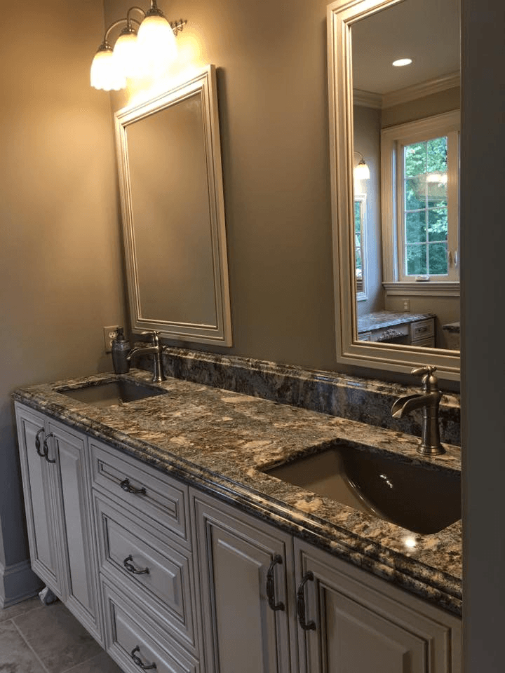 A bathroom with two sinks and two mirrors.
