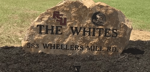 A large rock with the words the whites written on it