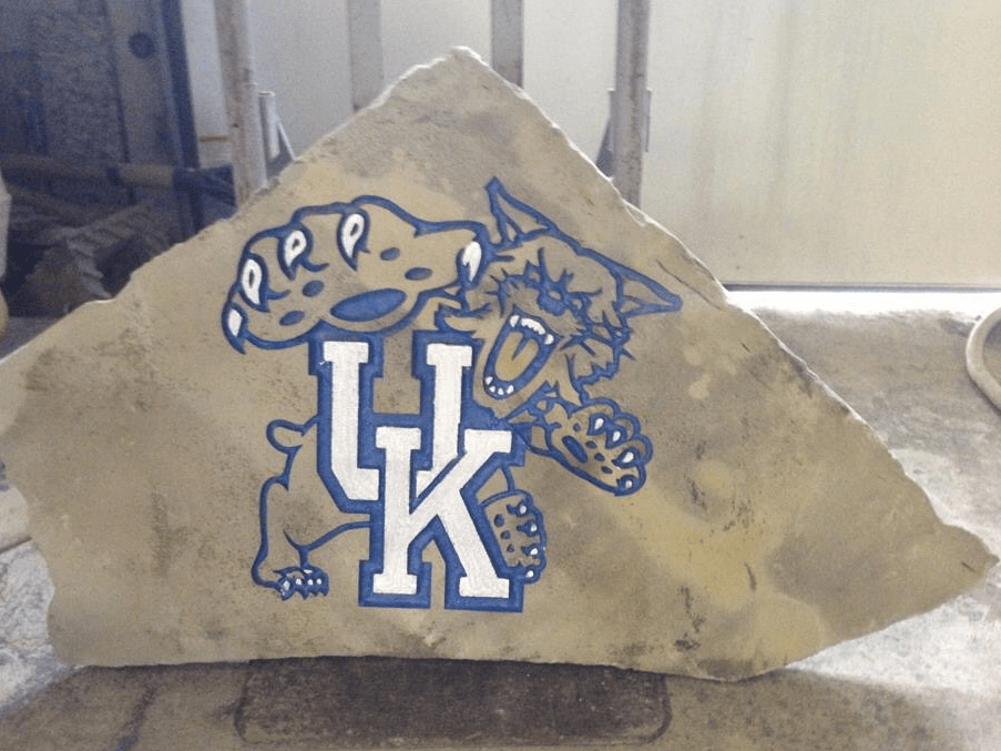 A large rock with the uk logo on it