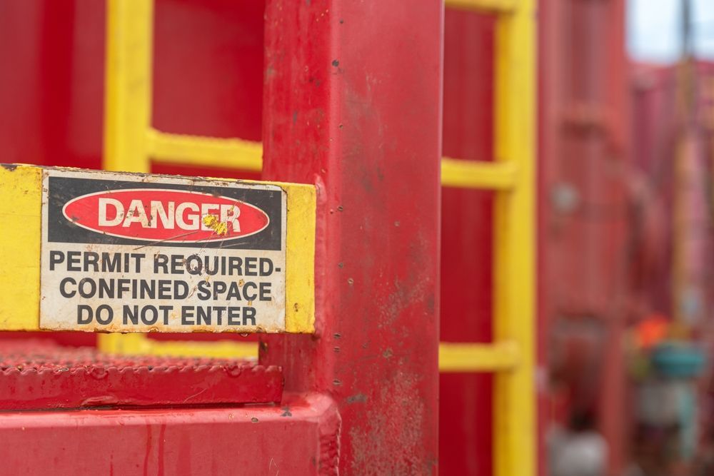Red and Yellow Industrial Structure With a Warning Sign — Hunter Fire & Safety in Coffs Harbour, NSW
