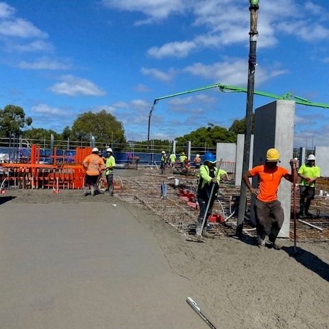 Construction Workers Pouring Concrete on a Sunny Day — Hunter Fire & Safety in Edgeworth, NSW