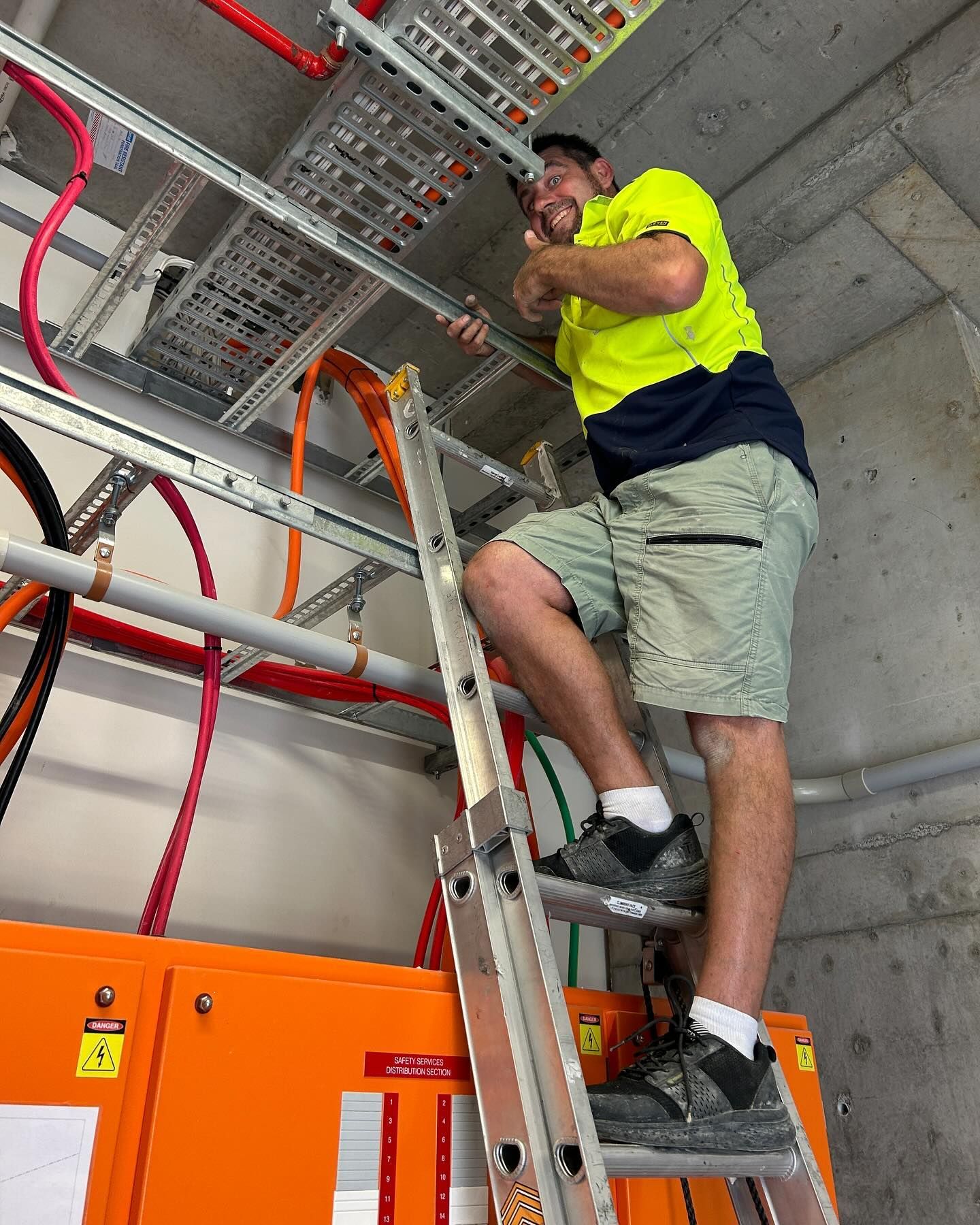 Construction Worker on Ladder Gives Thumbs Up — Hunter Fire & Safety in Edgeworth, NSW