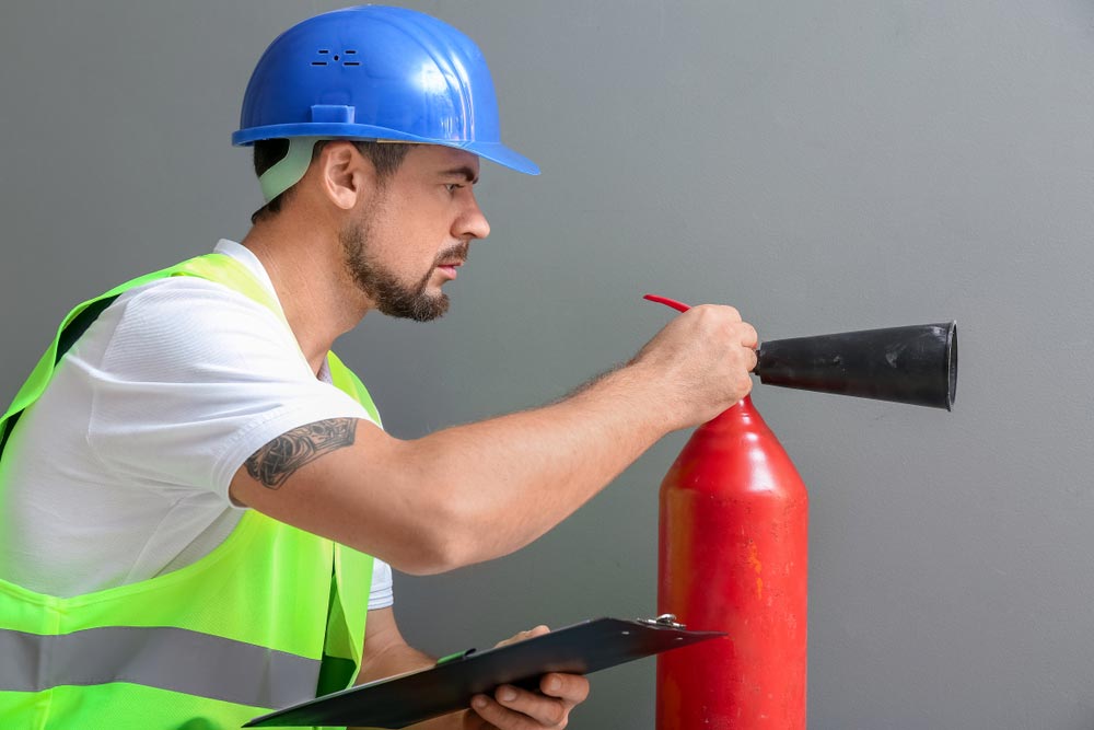 Fire Safety Checking The Fire Extinguisher — Hunter Fire & Safety in Central Coast, NSW
