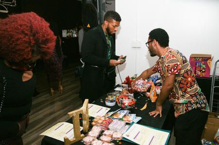 People at a table with snacks and papers during an indoor gathering