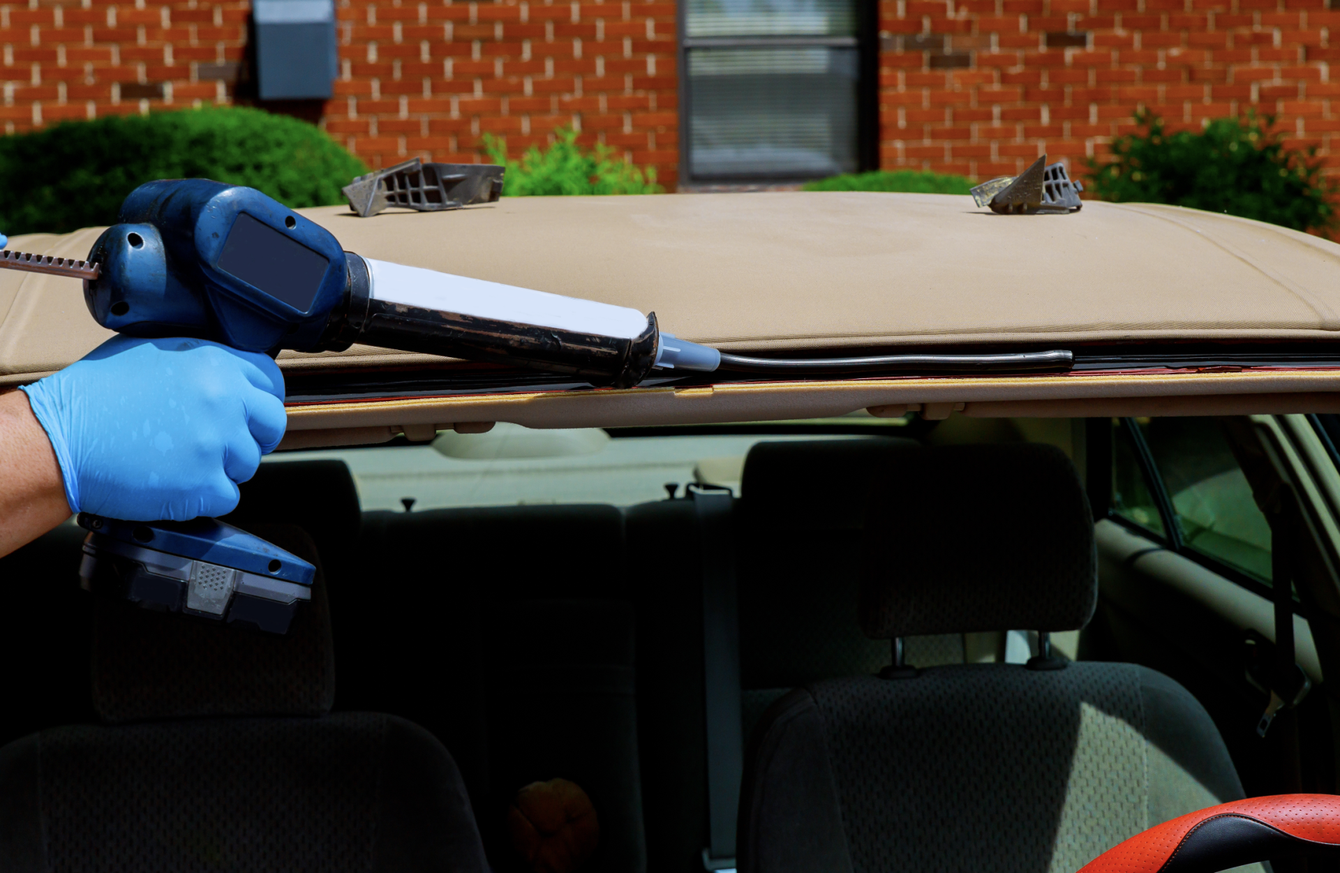 Sealing new windscreen on the car front frame