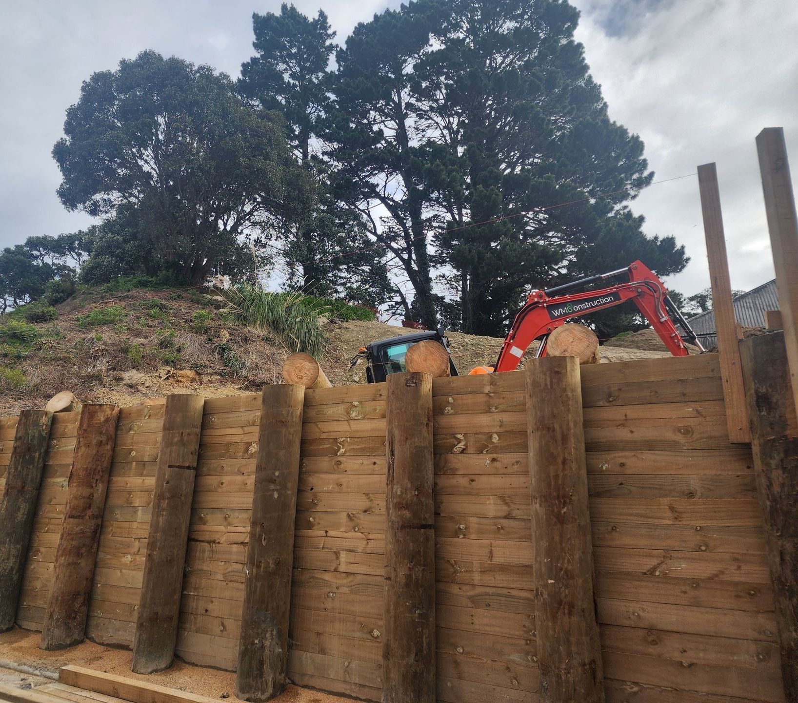 A wooden wall with a tractor in the background