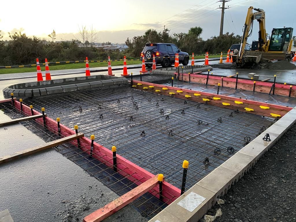 A car is driving down a road that is being built.