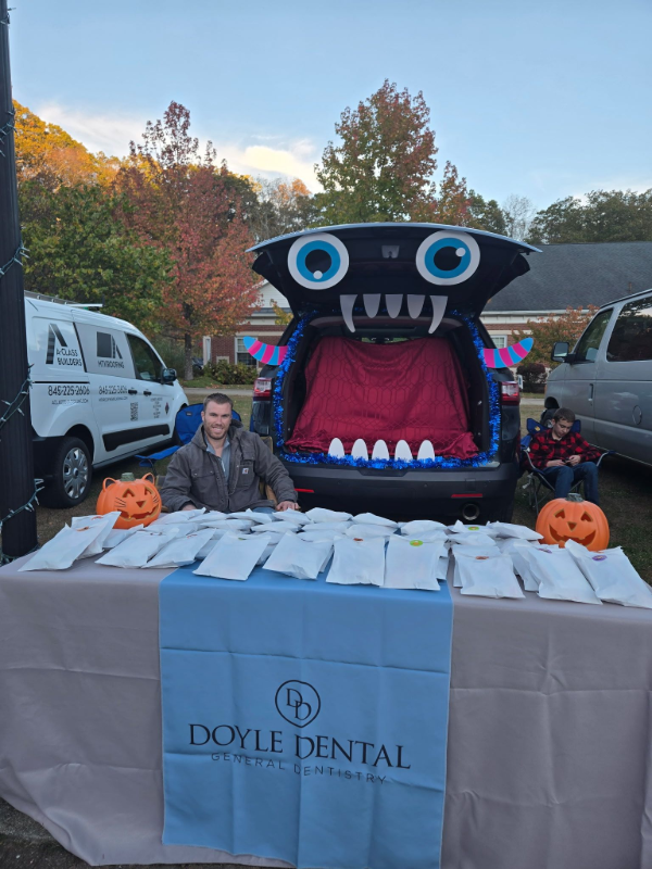 Halloween event table for Doyle Dental with jack-o’-lanterns and a large black monster mouth backdrop