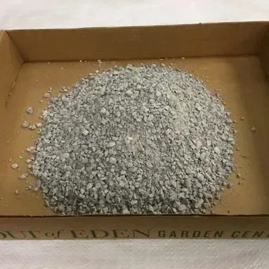Pile of gray gravel in a cardboard box