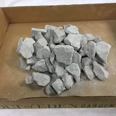 Pile of gray rocks in a cardboard box.
