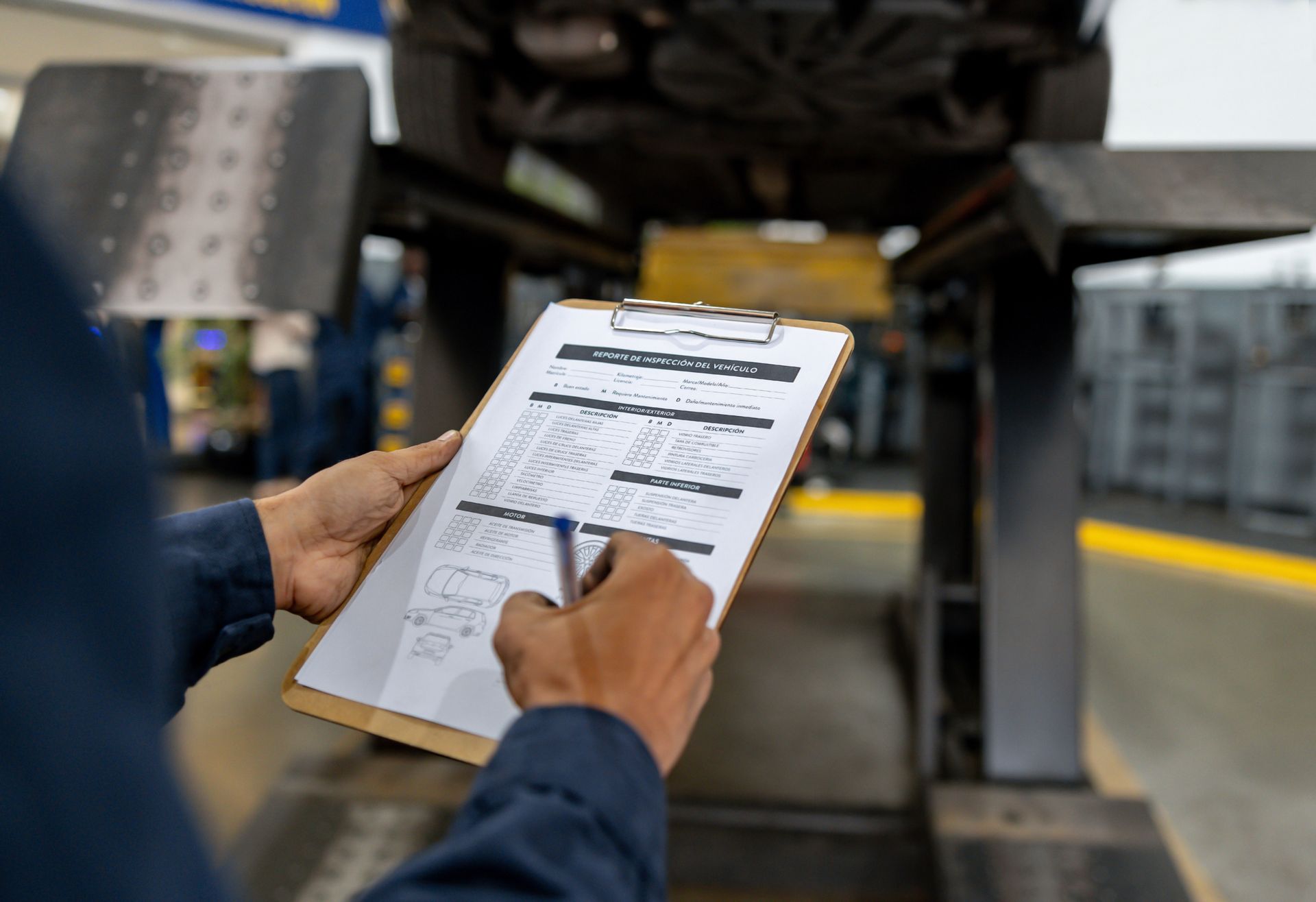 Mechanic making a diagnosis on a car at a garage.