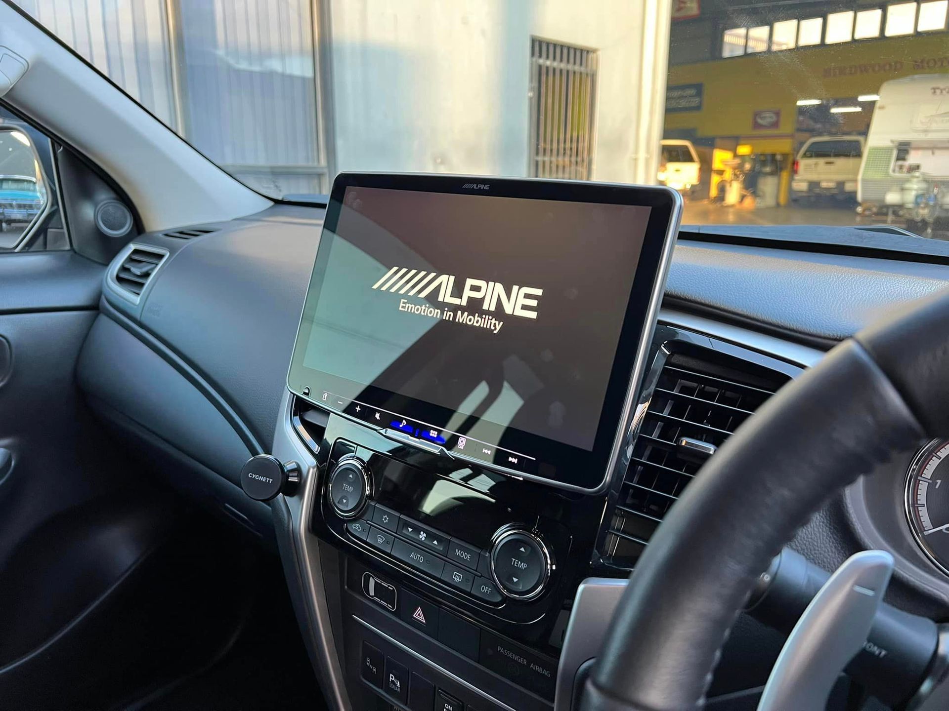 The dashboard of a car with a radio and a screen.