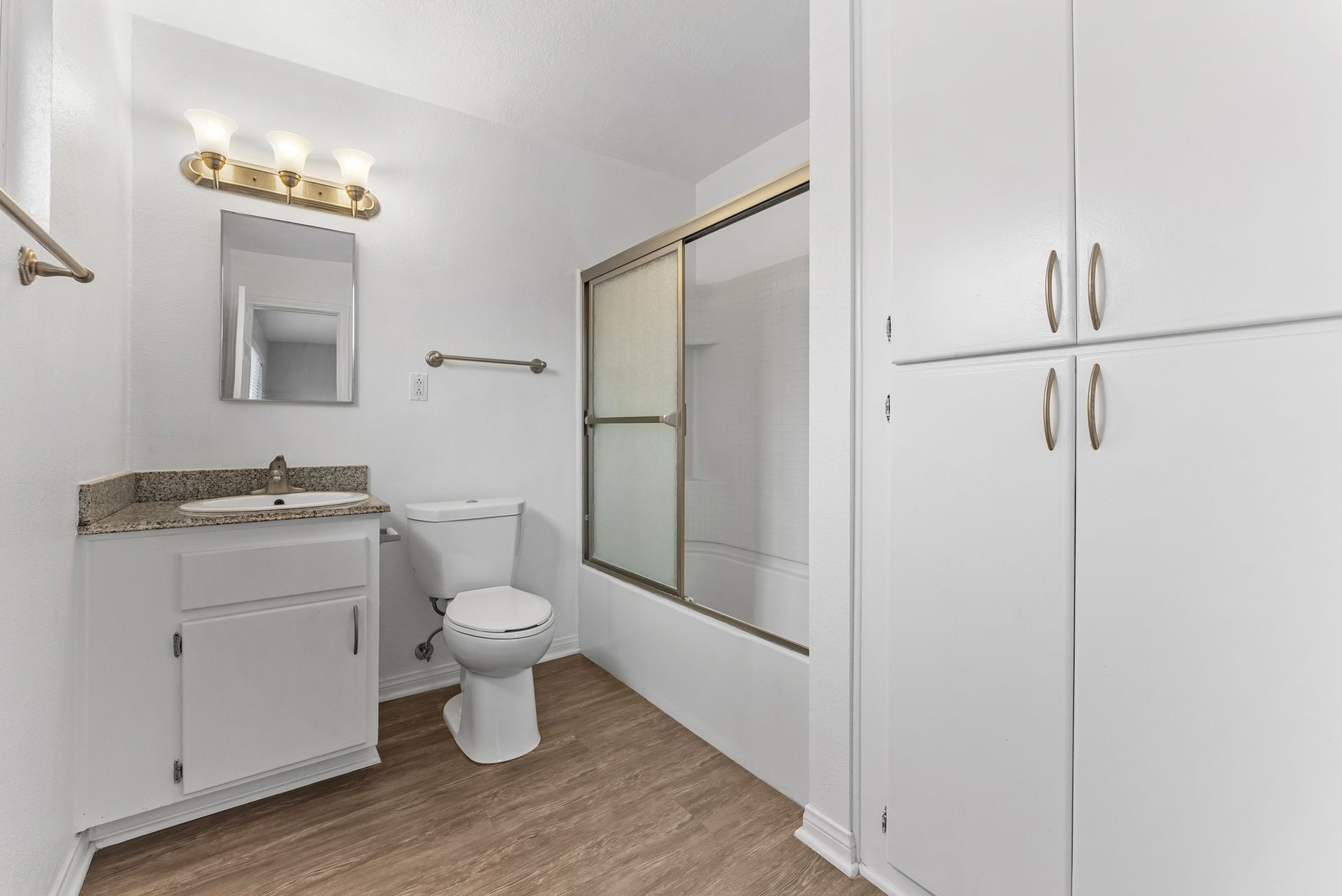 Gallery of exterior and interior photos of Northwind. Including walkways, gray archways, blue front doors, bbq grills, bedrooms with furniture, gated entrances, and main office.