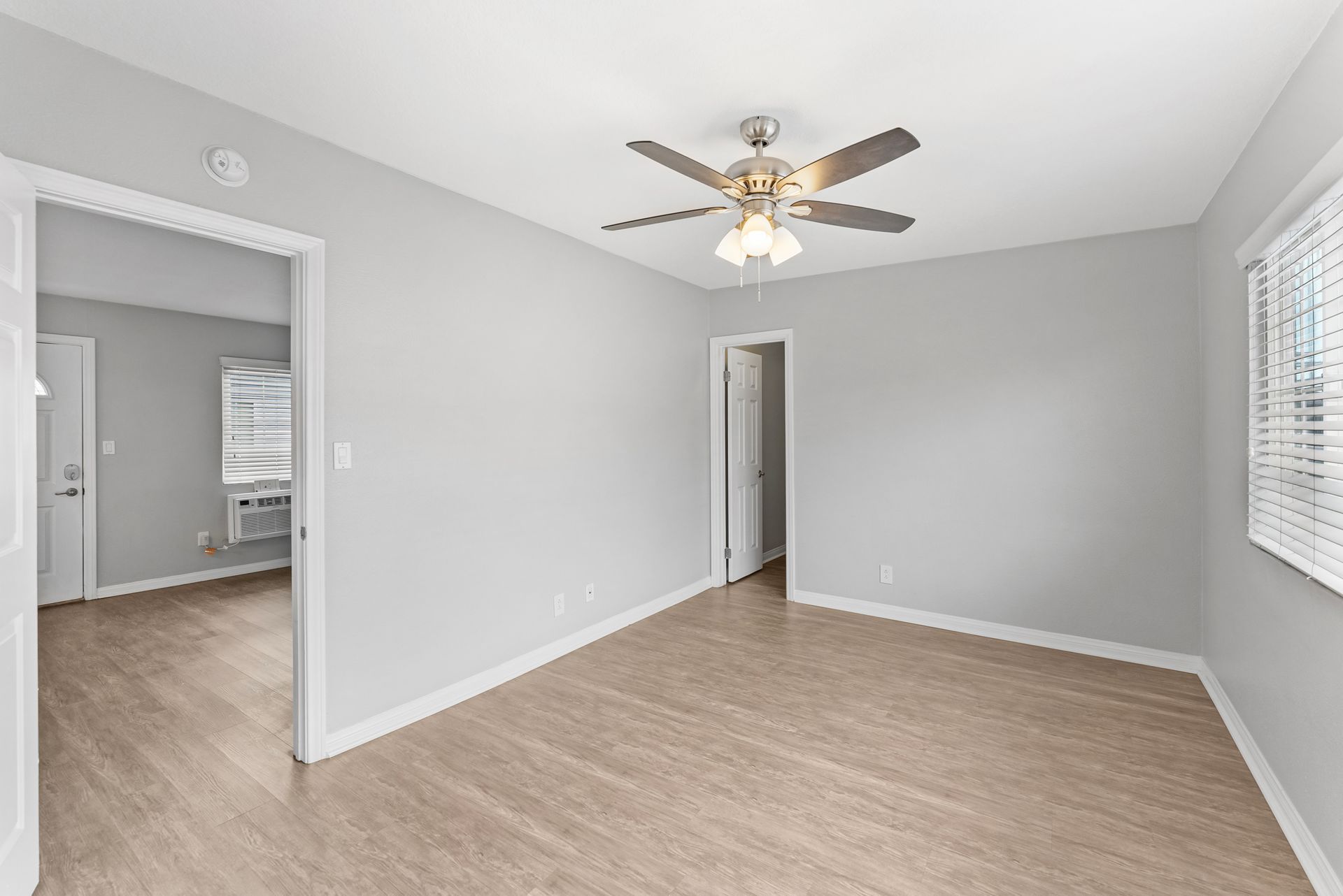 Gallery of exterior and interior photos of Northwind. Including walkways, gray archways, blue front doors, bbq grills, bedrooms with furniture, gated entrances, and main office.