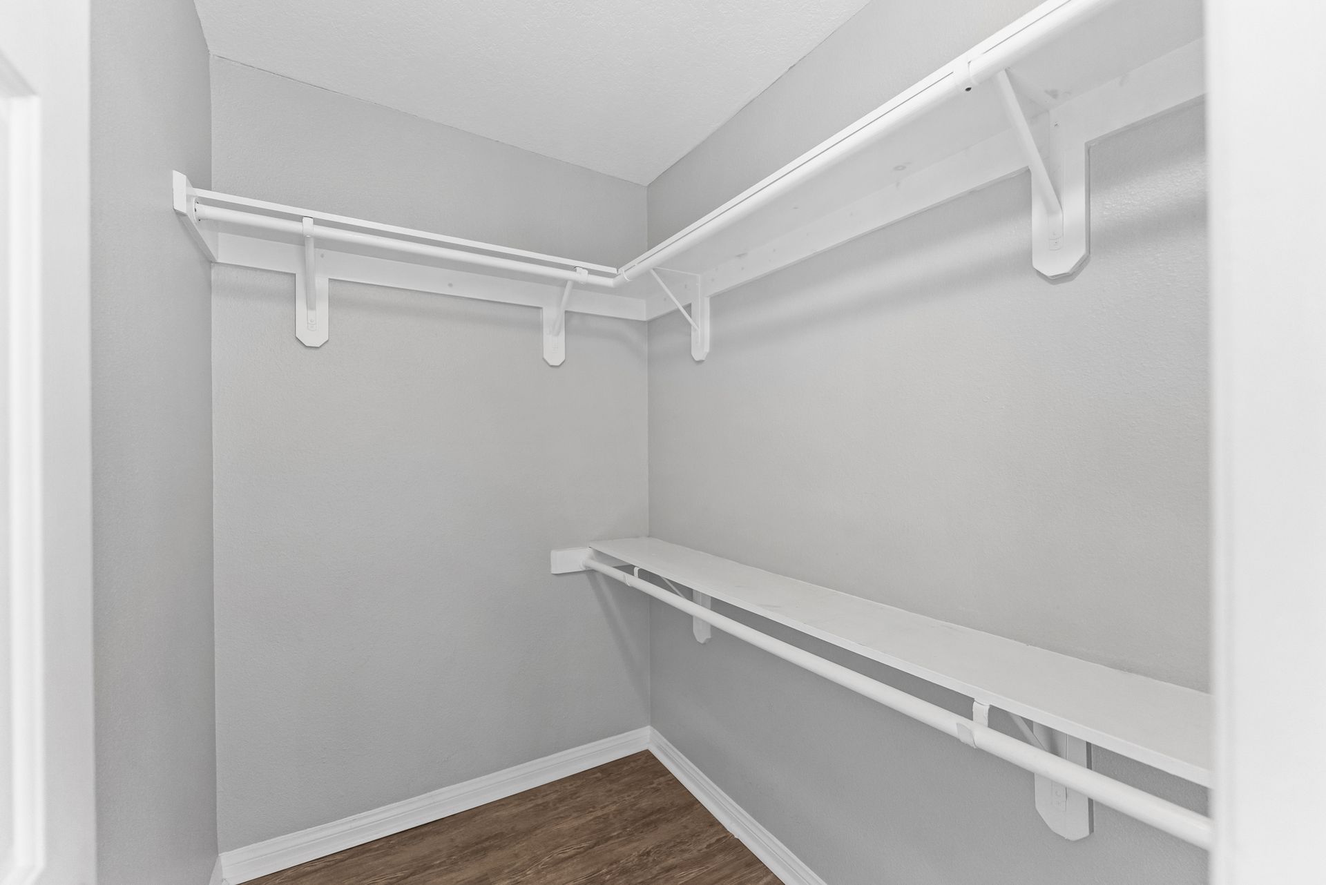 Gallery of exterior and interior photos of Northwind. Including walkways, gray archways, blue front doors, bbq grills, bedrooms with furniture, gated entrances, and main office.