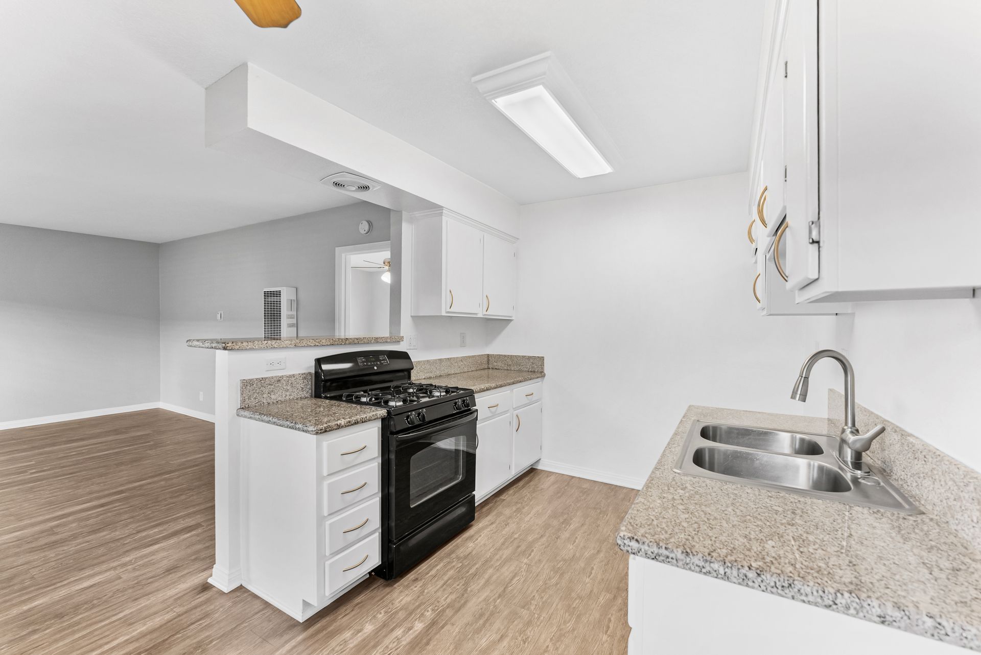 Gallery of exterior and interior photos of Northwind. Including walkways, gray archways, blue front doors, bbq grills, bedrooms with furniture, gated entrances, and main office.