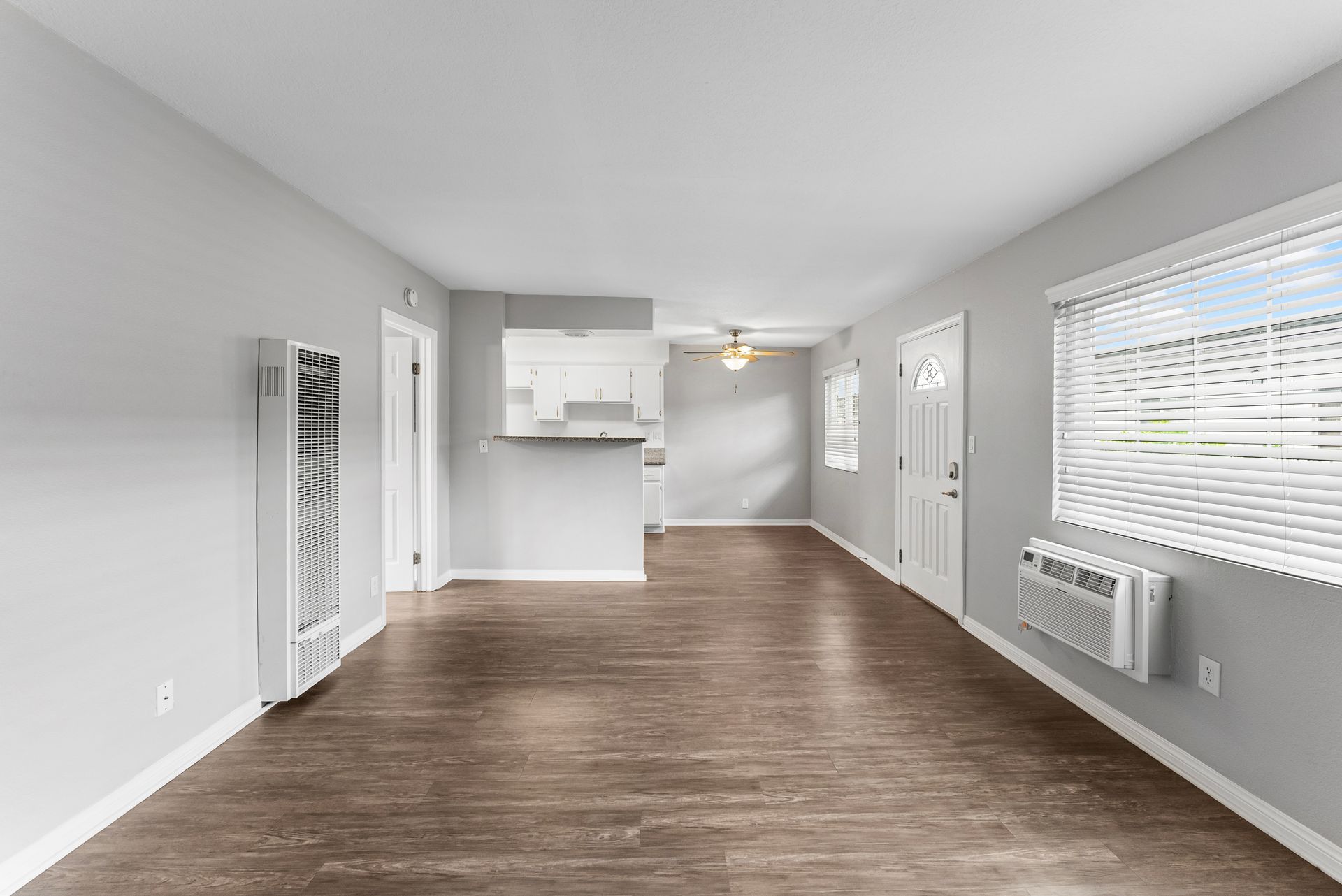 Gallery of exterior and interior photos of Northwind. Including walkways, gray archways, blue front doors, bbq grills, bedrooms with furniture, gated entrances, and main office.
