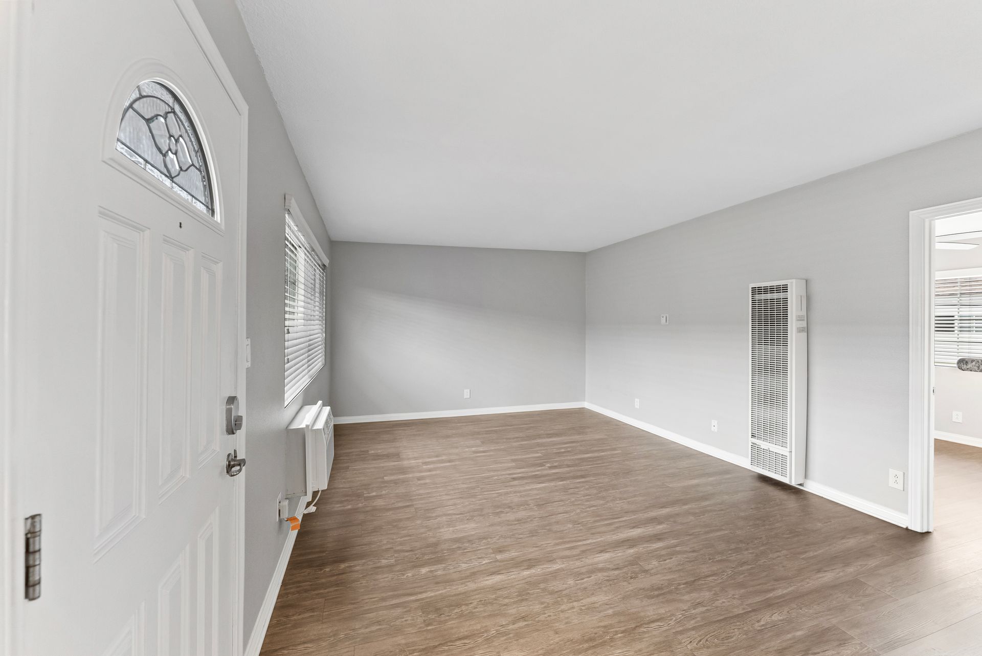 Gallery of exterior and interior photos of Northwind. Including walkways, gray archways, blue front doors, bbq grills, bedrooms with furniture, gated entrances, and main office.