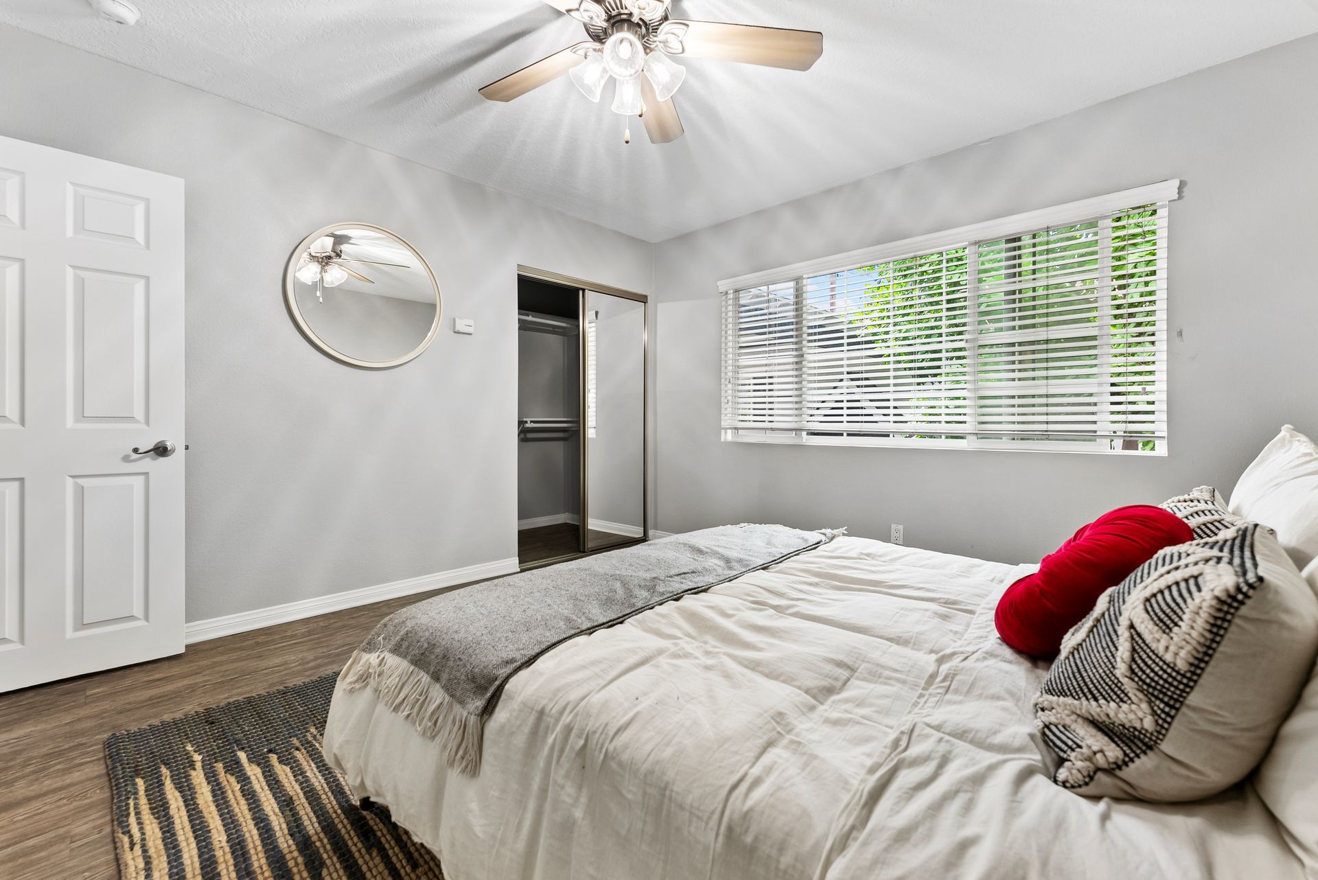 Gallery of exterior and interior photos of Northwind. Including walkways, gray archways, blue front doors, bbq grills, bedrooms with furniture, gated entrances, and main office.
