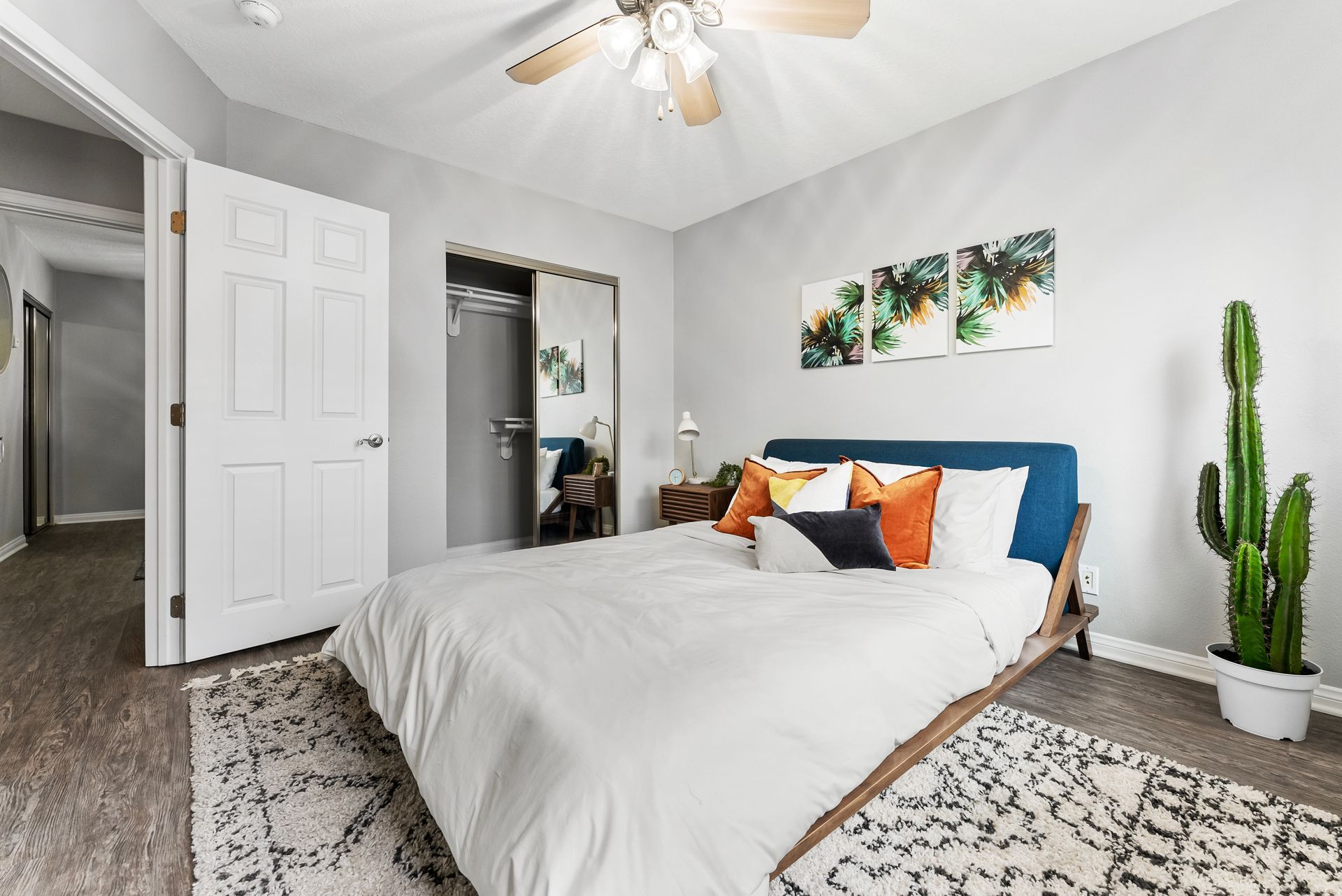 Gallery of exterior and interior photos of Northwind. Including walkways, gray archways, blue front doors, bbq grills, bedrooms with furniture, gated entrances, and main office.