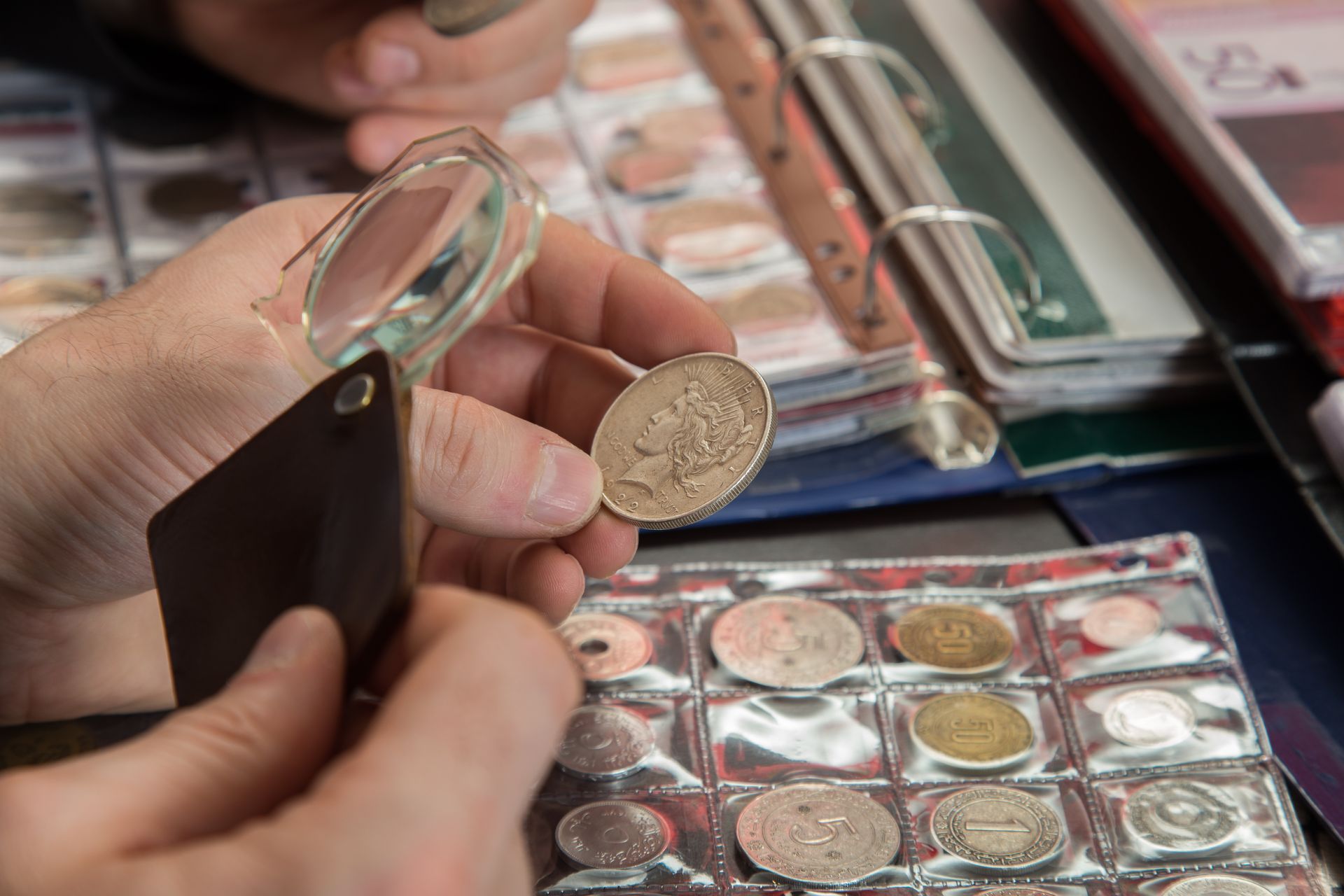Close-up of coins being inspected for condition and value.