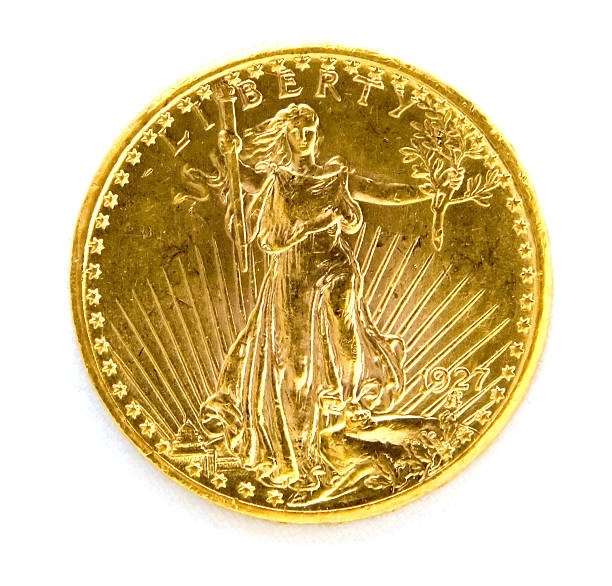 Gold coin featuring Lady Liberty holding a torch and olive branch, surrounded by radial sun rays.