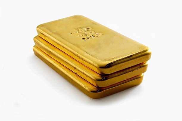 Stack of four gold bullion bars, showing a metallic, shiny appearance.