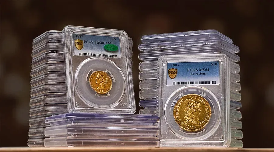 A bunch of coins on a table including one that says liberty