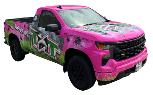 Customized pickup truck with colorful TNT graffiti-style wrap and oversized tires, rear view on white background