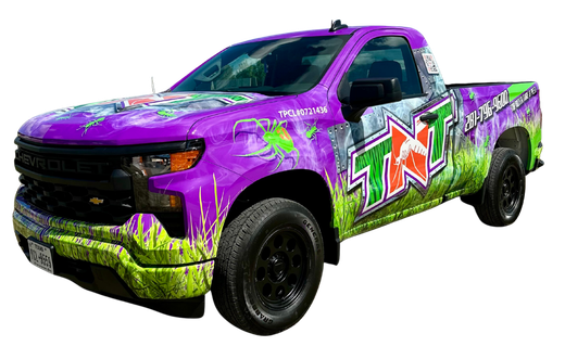 Customized pickup truck with colorful TNT graffiti-style wrap and oversized tires, rear view on white background