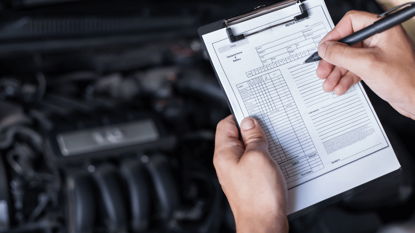 Mechanic with a checklist during inspection